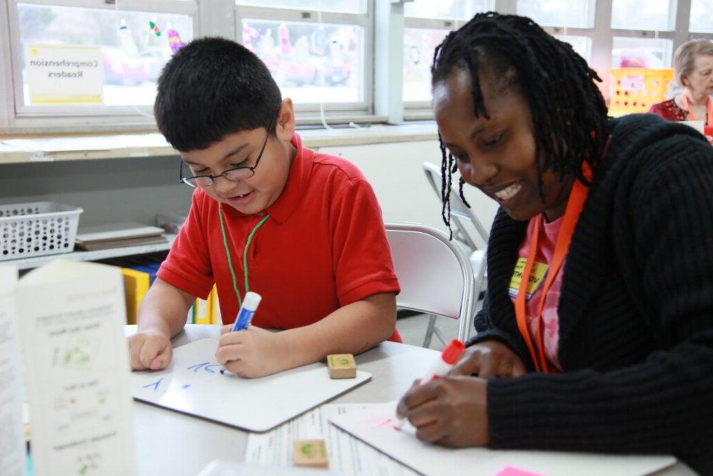 Tutor and student working on writing.