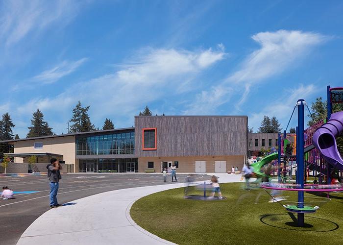 a playground with a building in the background