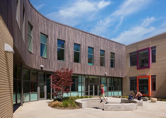 a courtyard area with a building curved around it